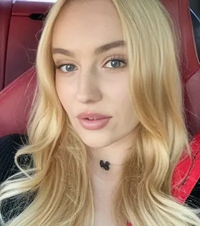 Blonde OnlyMonster creator taking a selfie in her car